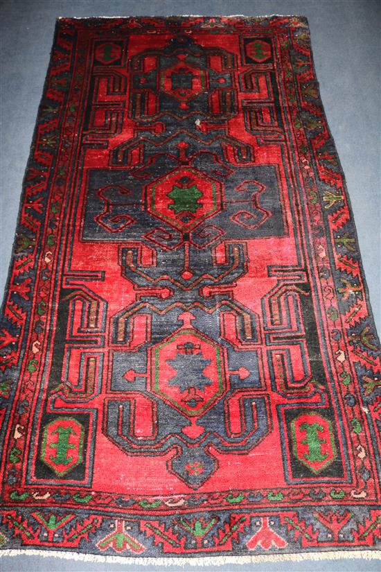 A Hamadan red and blue ground rug, 7ft 2in by 3ft 9in.